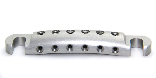 Lightweight aluminum stopbar for inexpensive guitar with clear anodized finish.