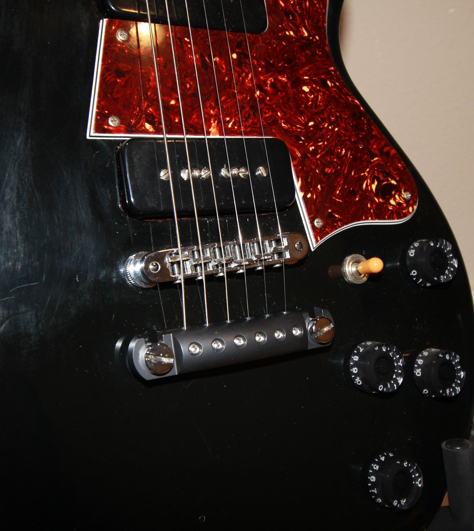 A black aluminum CNC Steadfast Stopbar on a black Gibson Les Paul guitar
