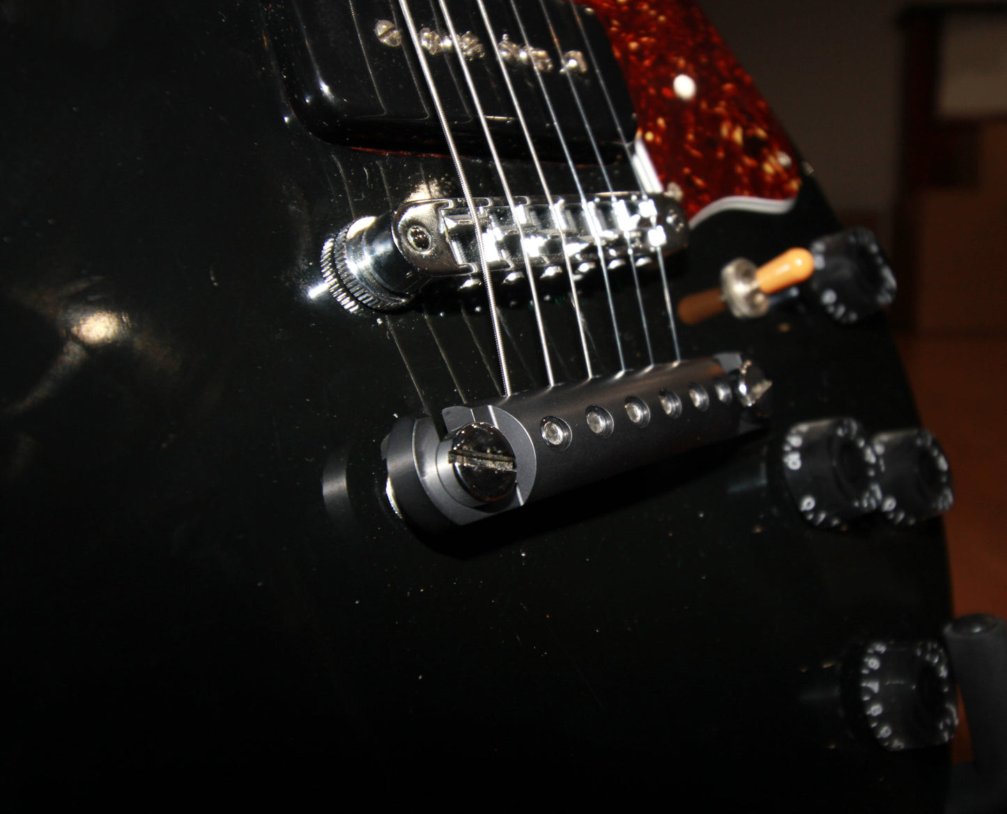 Detail view of black locking stopbar showing bridge and mounting hardware