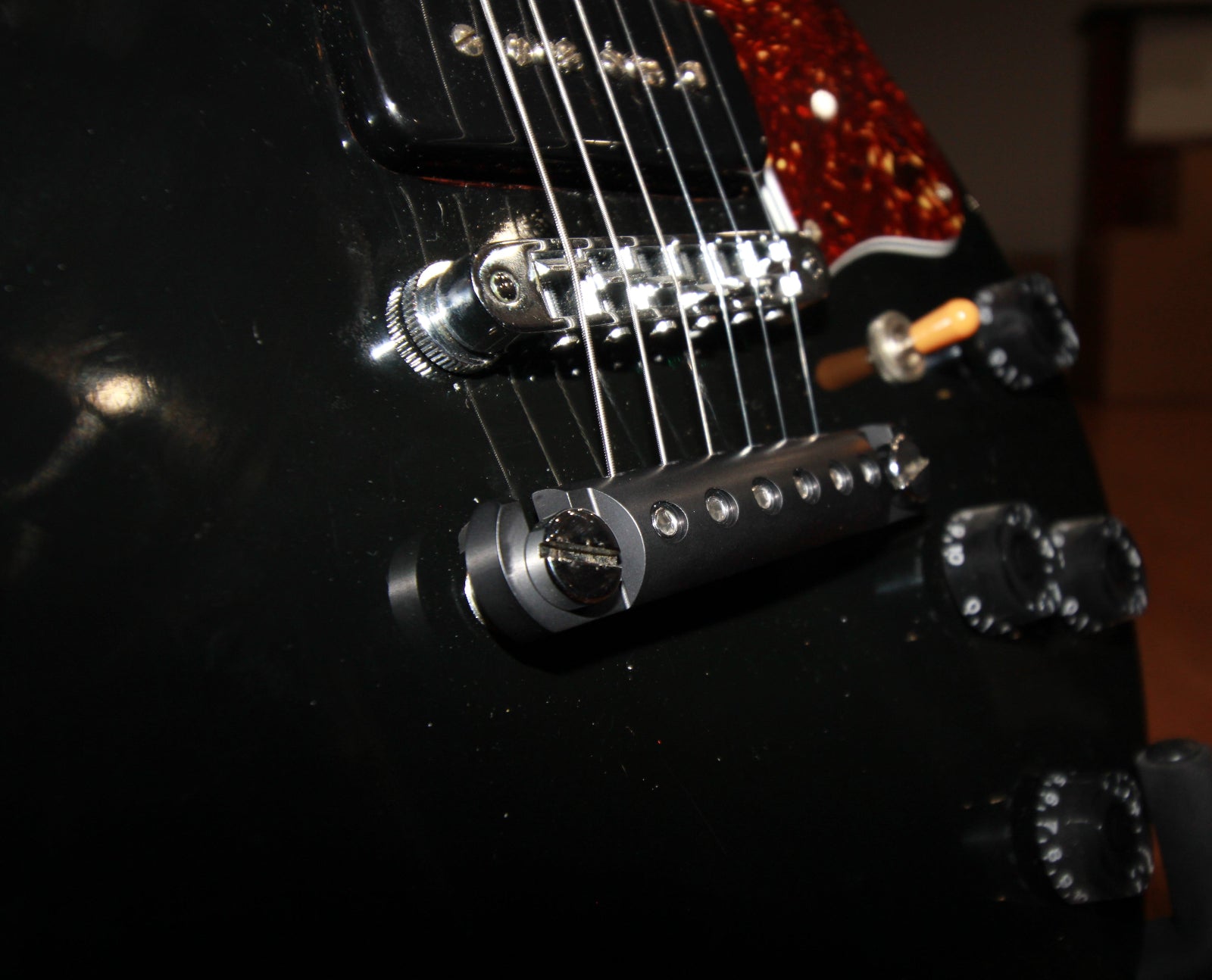 Detail view of black locking stopbar showing bridge and mounting hardware