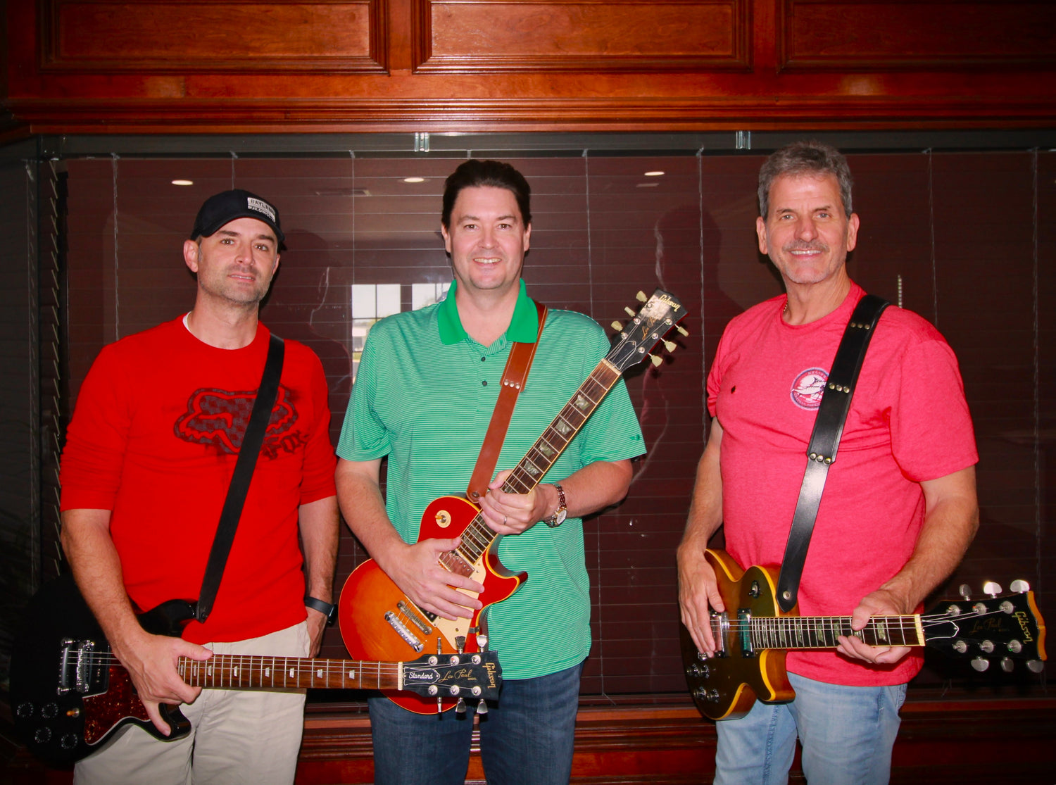 The Steadfast Designs team holding Gibson Les Pauls 